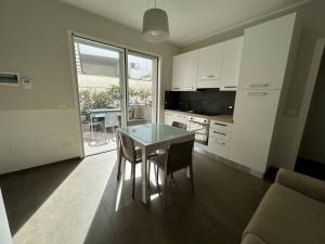 a kitchen with a table and chairs in a room at Lungomare Santa Caterina in Nardò