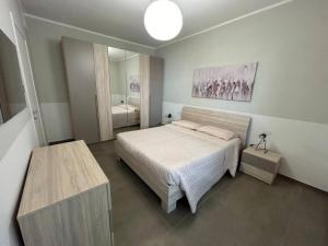 a bedroom with a bed and a large mirror at Lungomare Santa Caterina in Nardò