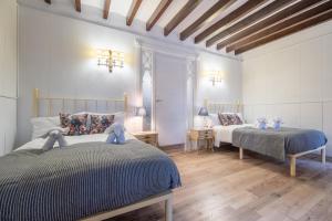 a bedroom with two beds with teddy bears on them at Moli dels Reis in Palma de Mallorca +33 photos