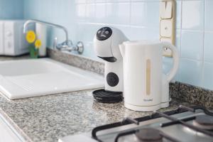 a coffee maker is sitting on a kitchen counter at Flamingo in Tavernes de Valldigna