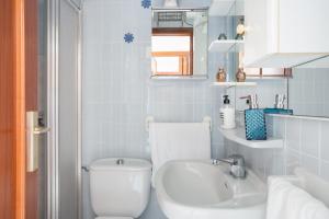 a bathroom with a white toilet and a sink at Flamingo in Tavernes de Valldigna +25 photos