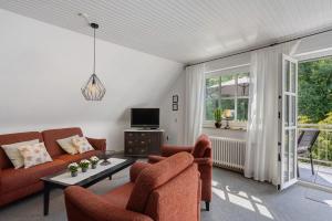a living room with two couches and a tv at Ferienwohnung Riedel in Sundern