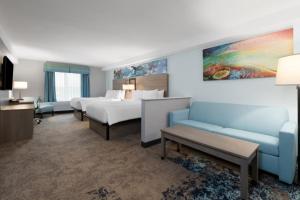 a hotel room with a bed and a couch at Garner Hotel Virginia Beach North by IHG in Virginia Beach +51 photos