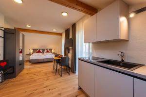 a kitchen with a sink and a room with a bed at Weinangerhof St Pauls in Missiano +72 photos