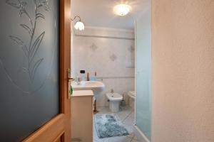 a small bathroom with a sink and a toilet at La Casa Di Pasky in Roisan +21 photos