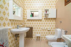 a bathroom with a sink and a toilet at Il Comandante in Piedimonte Etneo +16 photos