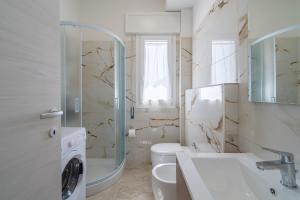 a bathroom with a toilet and a sink and a shower at Littiricci in Marzamemi +43 photos