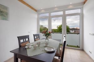 a dining room with a table and chairs and a window at Urlaub Ostholstein in Stockelsdorf