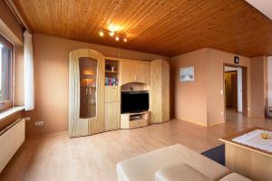 a large living room with a television and a couch at Urlaub Ostholstein in Stockelsdorf