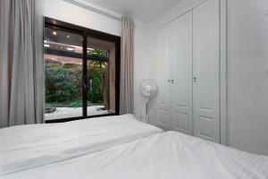 a bedroom with a white bed and a window at Apartment Coto Real in Manilva +22 photos
