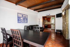a kitchen and dining room with a table and chairs at Moinho das Esteveiras in A dos Cunhados +28 photos