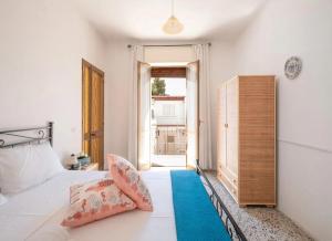a bedroom with a bed and a large window at Sabbia e Sorrisi Sea View in Porto Cesareo