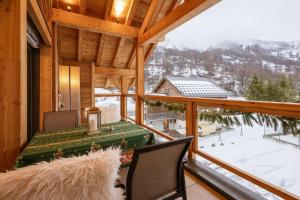 a view from the balcony of a cabin with a table at Chalet-Spa Le Cervin in Valloire