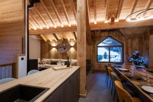 a kitchen and dining room with a christmas tree at Chalet-Spa Le Cervin in Valloire