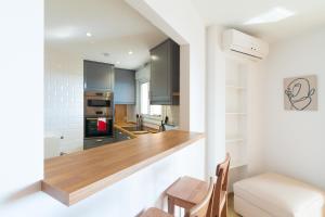 a kitchen with a counter and a dining room at Large Apartment Marbella del Mar in Marbella