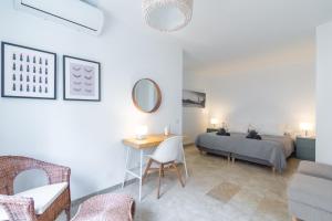 a bedroom with a bed and a table and a desk at Large Apartment Marbella del Mar in Marbella +18 photos