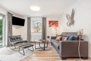 a living room with a couch and a chair at Haus Gertrud in Wiek auf Rügen