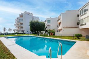 a swimming pool in front of a building at Large Apartment Marbella del Mar in Marbella