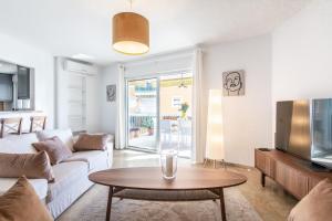 a living room with a white couch and a table at Large Apartment Marbella del Mar in Marbella