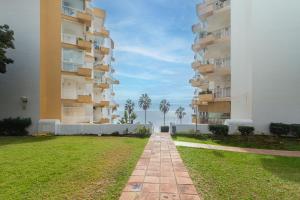 a walkway between two tall apartment buildings at Large Apartment Marbella del Mar in Marbella