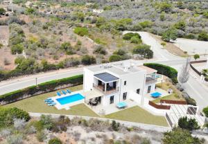 an aerial view of a white house with a swimming pool at Ca na Magdalena in Santanyi