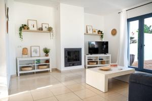 a living room with a tv and a couch at Ca na Magdalena in Santanyi