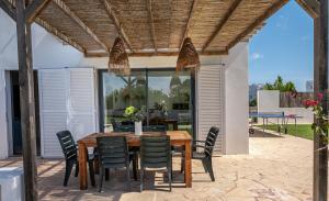 a wooden table and chairs on a patio at Ca na Magdalena in Santanyi