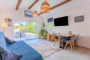 a living room with a blue couch and a table at Studio Bormes in Bormes-les-Mimosas
