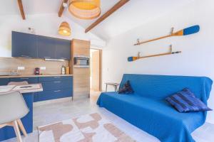 a blue bed in a room with a kitchen at Studio Bormes in Bormes-les-Mimosas