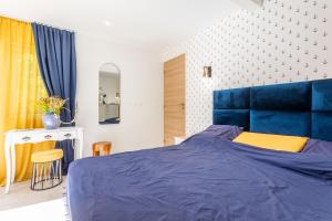 a bedroom with a blue bed with a blue headboard at Studio Bormes in Bormes-les-Mimosas