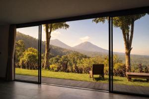 a room with a large window with a view of a mountain at Bali Barn Village in Munduk