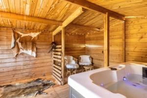 a bathroom with a tub in a wooden cabin at db Staycation Ferienpark in Niedenstein +167 photos