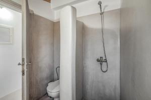a bathroom with a toilet and a shower at Angel’s studio in Potamós +16 photos