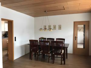 a dining room with a table and chairs at Am Trapp in Padberg