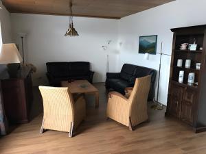 a living room with a couch and a table and chairs at Am Trapp in Padberg
