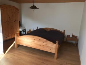 a bedroom with a wooden bed in a room at Am Trapp in Padberg