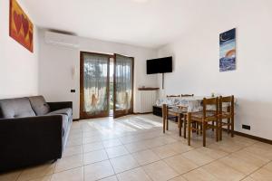 a living room with a table and a couch at Appartamento Assenza 9 in Brenzone sul Garda