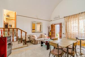 a living room with a table and a couch at Elena Inn in Matino
