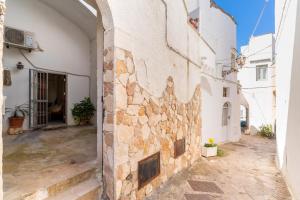 an alley in a building with a stone wall at Elena Inn in Matino