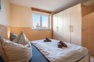 a bedroom with a bed with pillows on it at Habichtssicht in Buschvitz