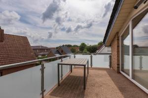 a table on the balcony of a house at Ferienhaus Manni Dg in Büsum