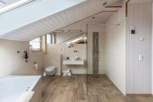 a bathroom with a shower and a sink and a toilet at Ferienhaus Manni Dg in Büsum +22 photos