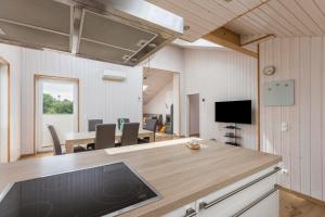a kitchen with a table and a dining room at Ferienhaus Manni Dg in Büsum