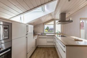 a kitchen with white appliances and a large window at Ferienhaus Manni Dg in Büsum