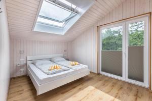 a bedroom with a bed and a skylight at Ferienhaus Manni Dg in Büsum