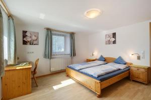 a bedroom with a bed and a desk in it at Nagelehof in Ridanna