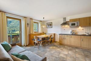 a living room with a couch and a table in a kitchen at Nagelehof in Ridanna