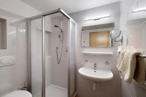 a bathroom with a shower and a sink and a toilet at Nagelehof in Ridanna +32 photos