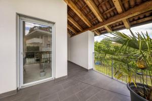 an indoor patio with a sliding glass door and a plant at Angerblick Apartment in Appiano sulla Strada del Vino