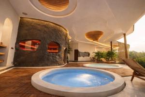 a large bathroom with two large jacuzzi tub at Bali Barn Village in Munduk